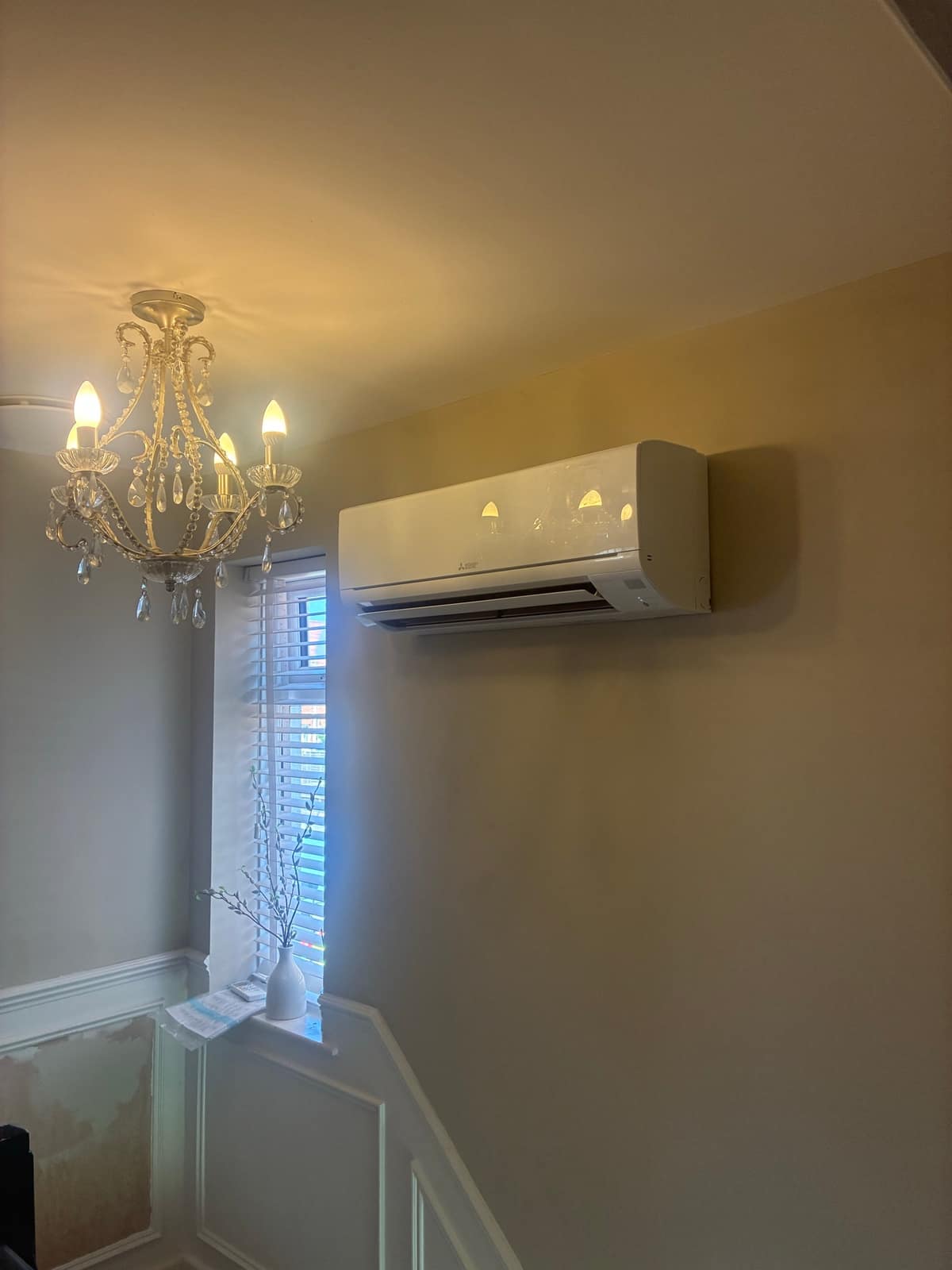 Wall-mounted indoor air conditioning unit installed on a landing in a Torbay home