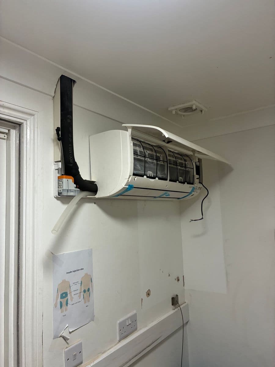Engineer servicing an air conditioning indoor unit